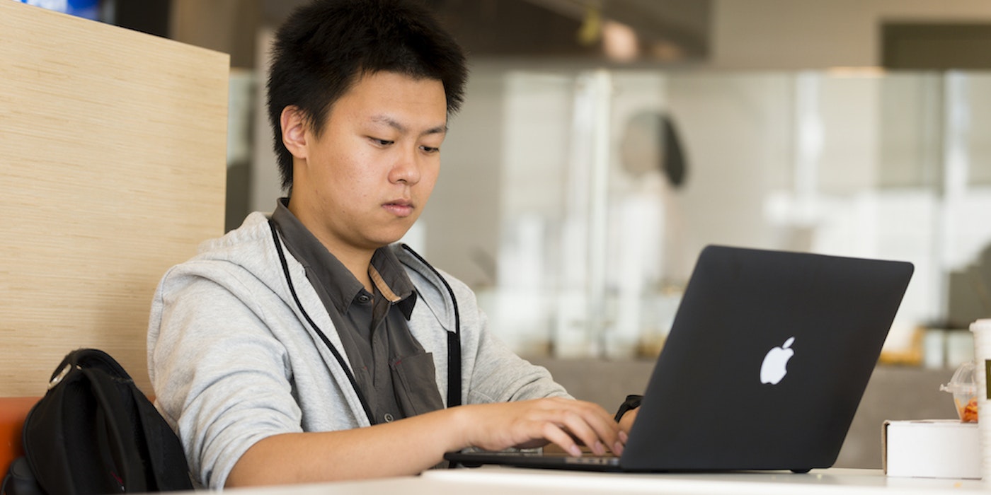 A student types on a laptop.