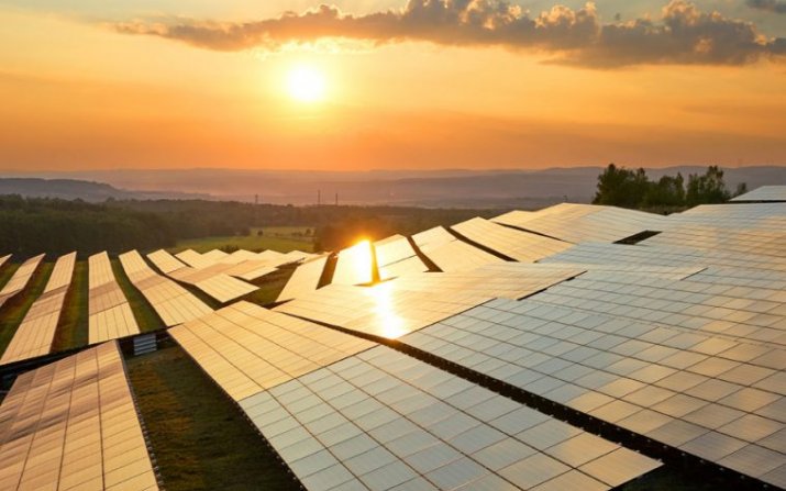 The sun shines on a group of solar panels.