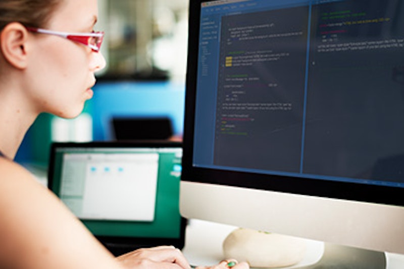 	A woman typing on a computer