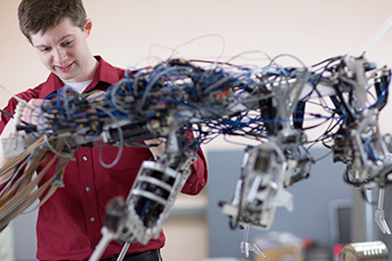 A man working with a robot