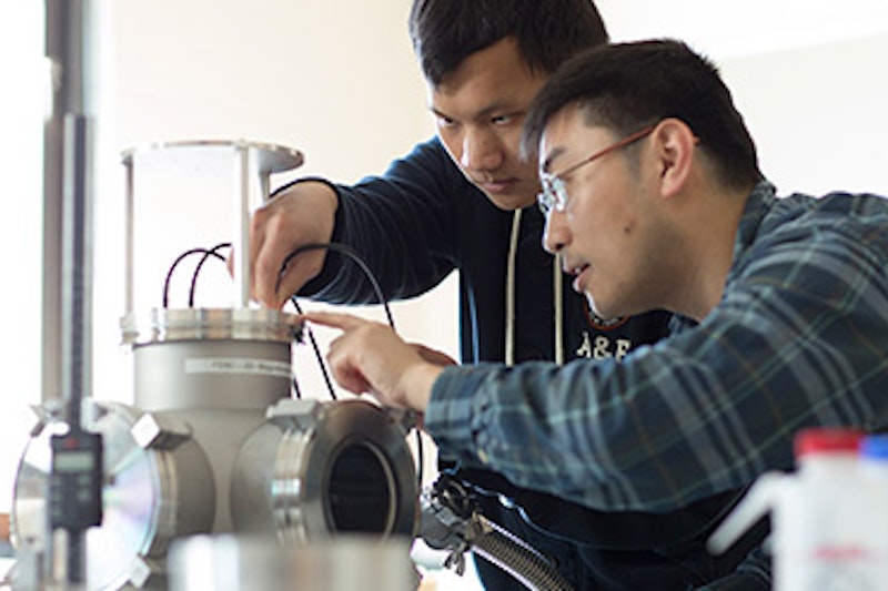 Two men working together in a scientific experiment